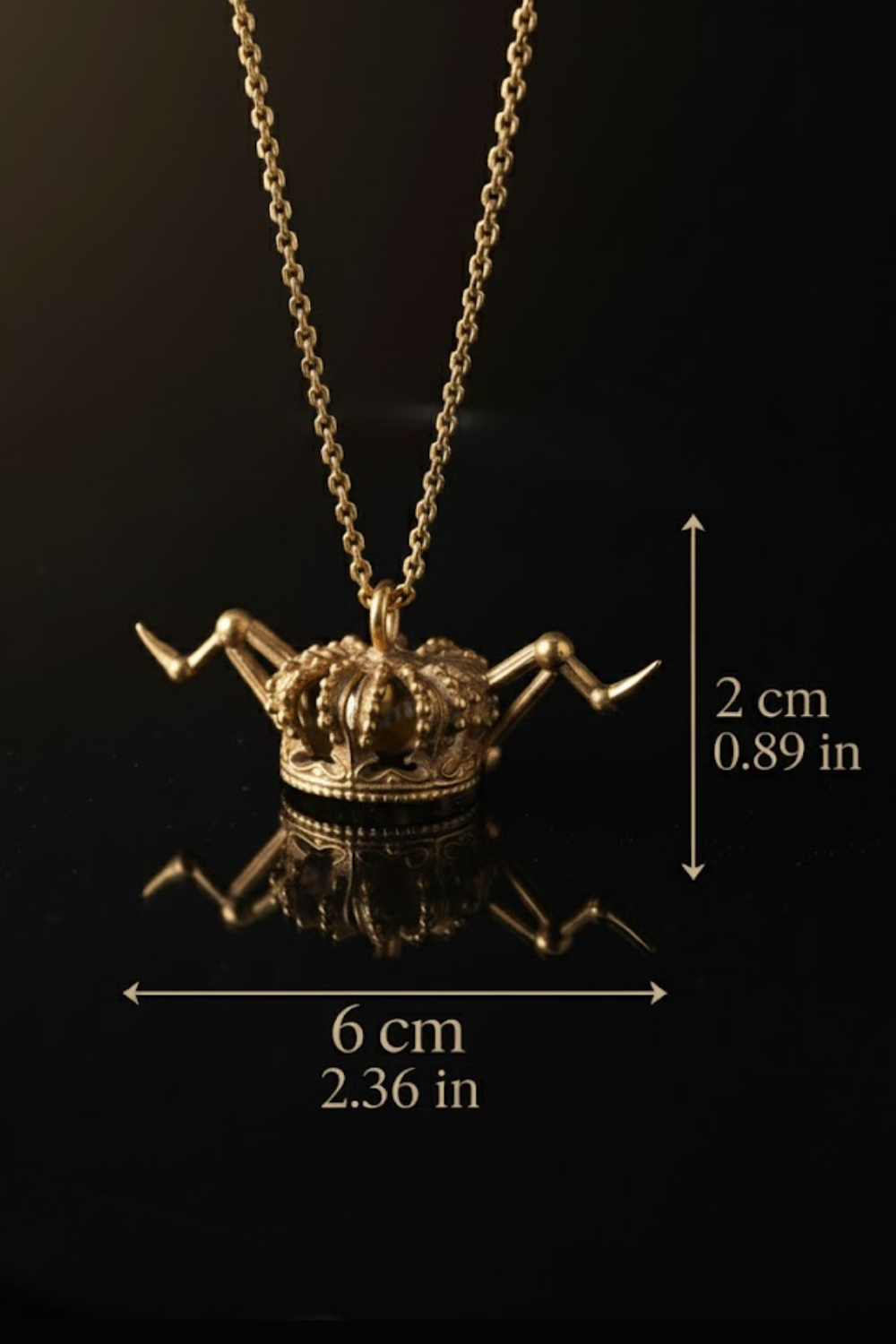 A gold-colored necklace with a crown-shaped pendant is displayed against a black background.