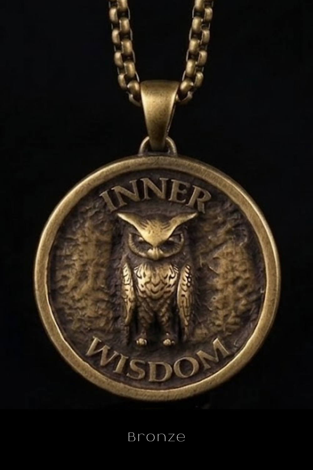 A bronze pendant with an owl design and the words " Inner Wisdom" engraved on it.