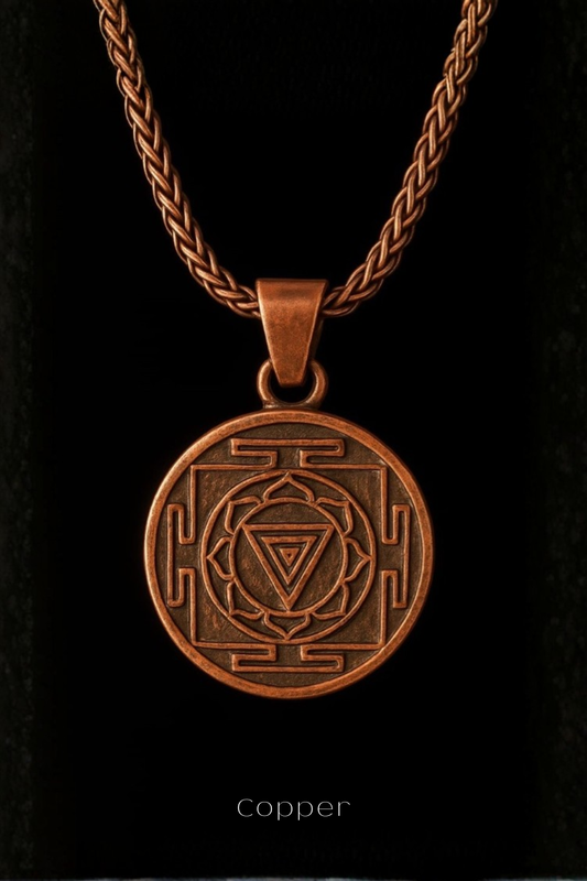 A copper-colored pendant necklace with a circular medallion featuring a geometric design.