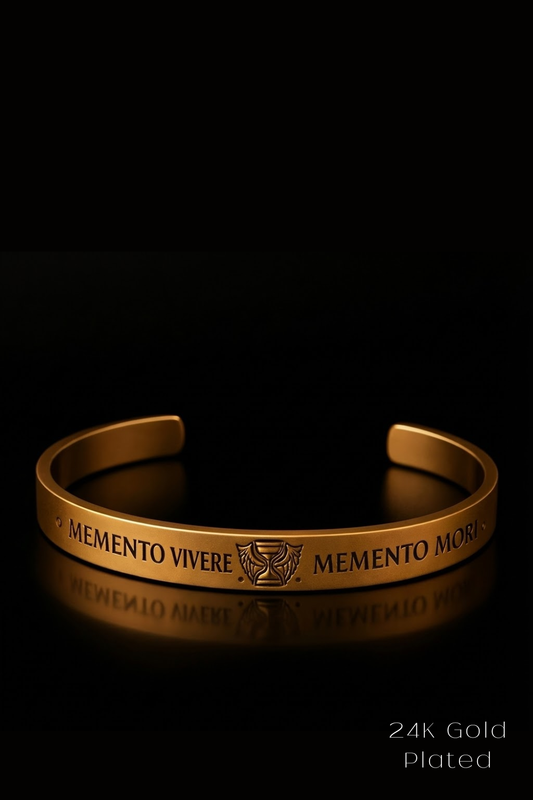 A gold-plated bracelet with the text "MEMENTO VIVERE MEMENTO MORI" engraved on it, which translates to "Memento, here is a reminder" in Latin.