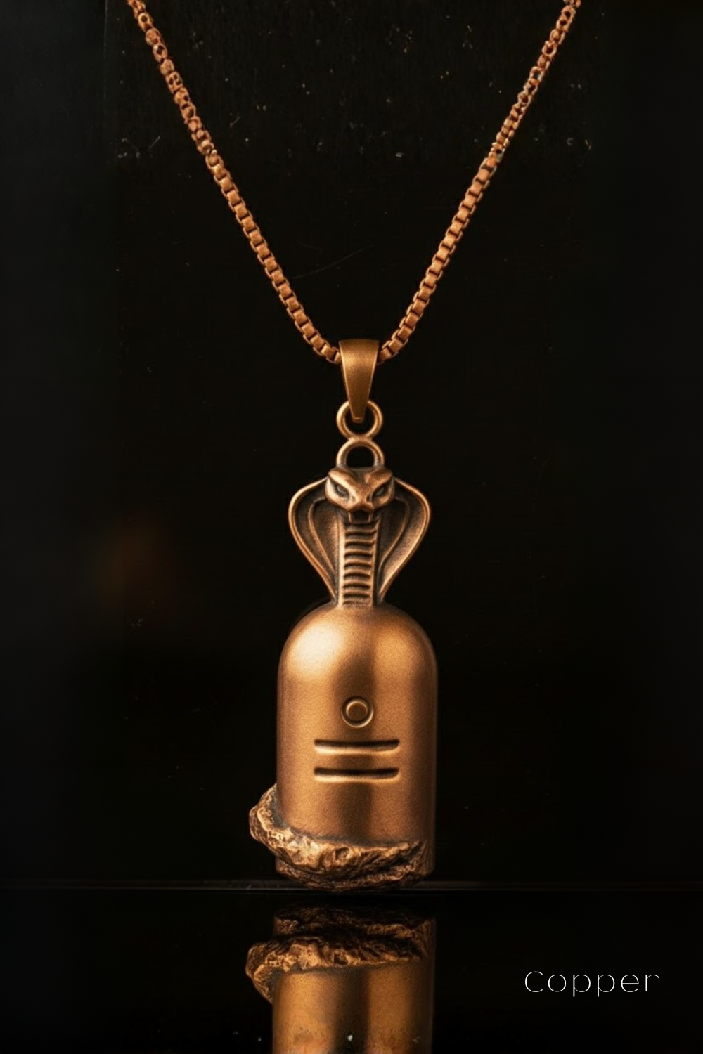 A copper-colored pendant necklace with a snake design on a black background.