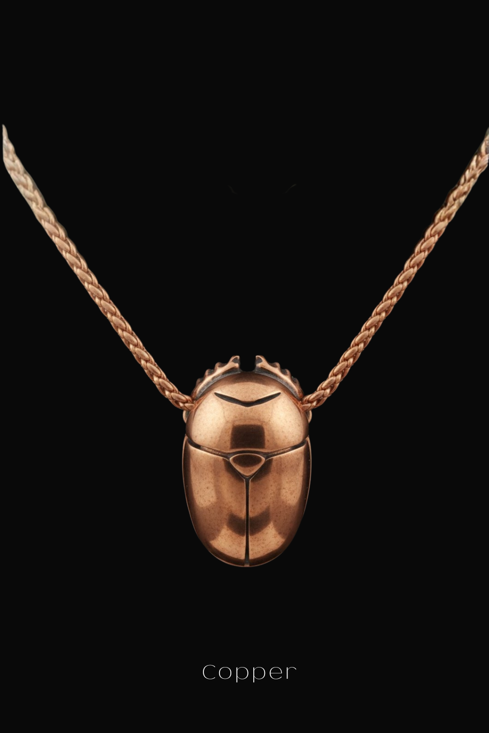 A copper-colored pendant necklace with a braided design, suspended against a black background.