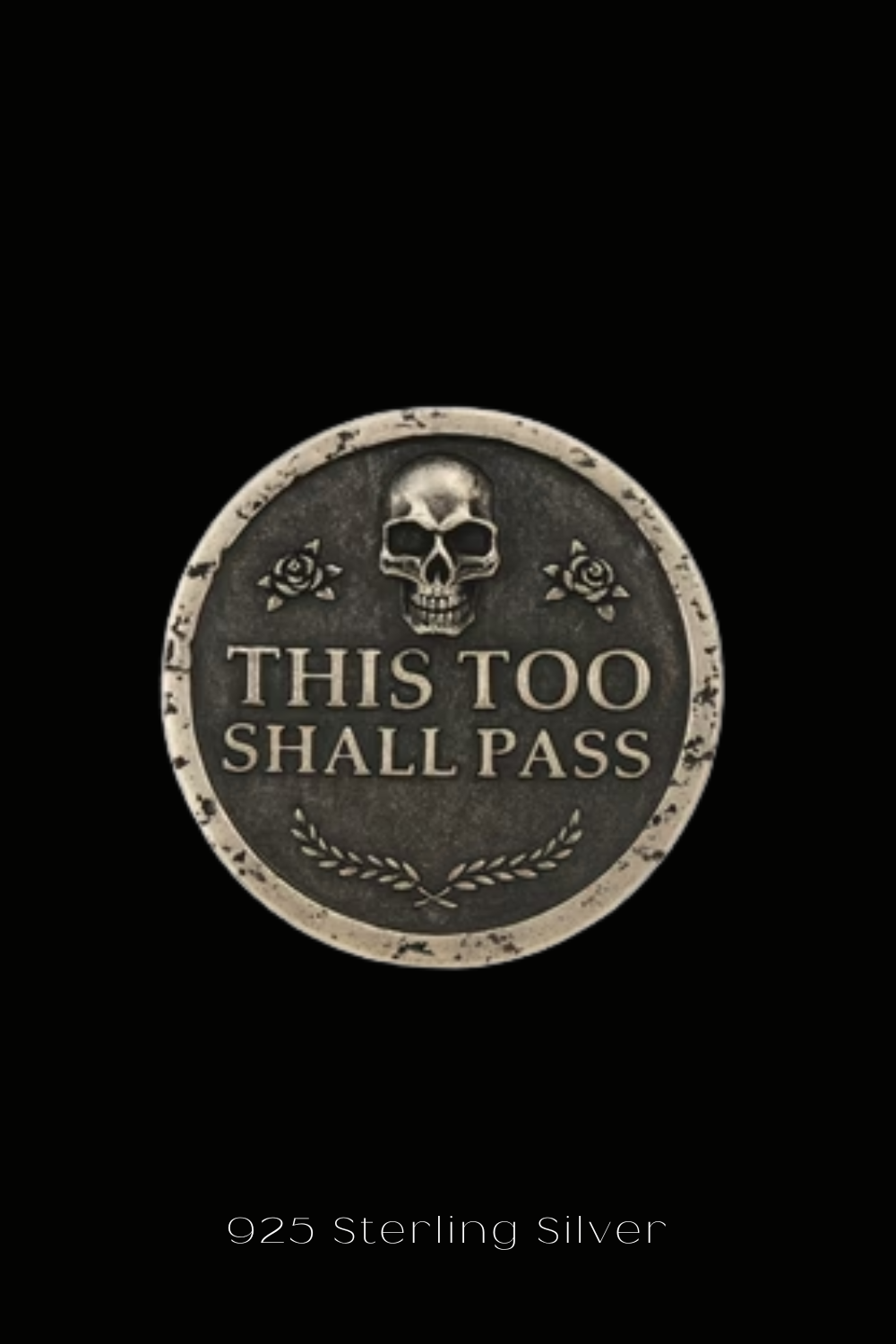 The image is a silver coin with a skull and rose design, and the text "THIS TOO SHALL PASS" printed on it.