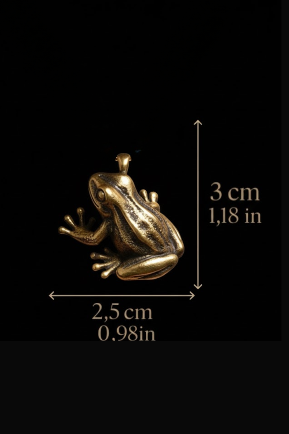 A gold-colored frog figurine is shown against a black background, with measurements indicating its size.