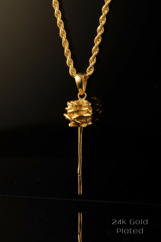 A 24k gold plated pendant necklace with a rose-shaped pendant is displayed against a black background.