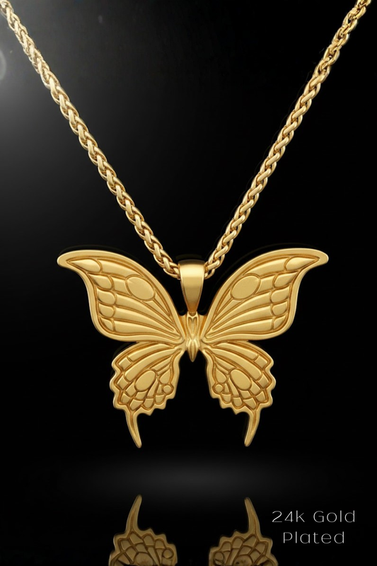 A 24k gold plated butterfly pendant necklace against a black background.