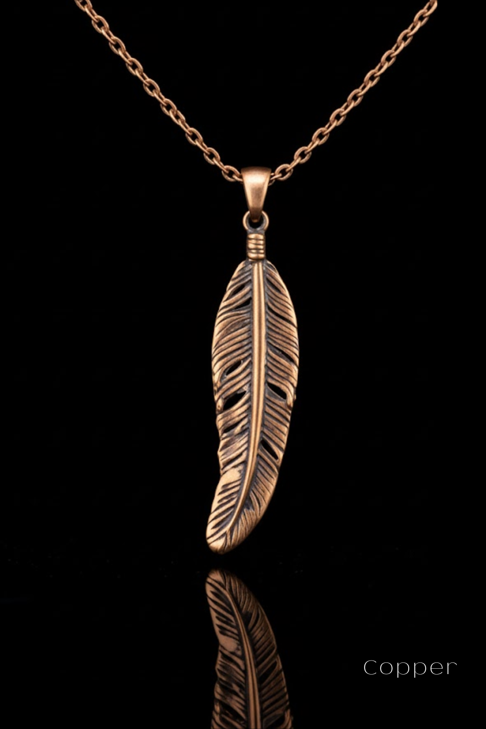 A copper-colored pendant necklace with a detailed feather pendant is displayed against a black background.