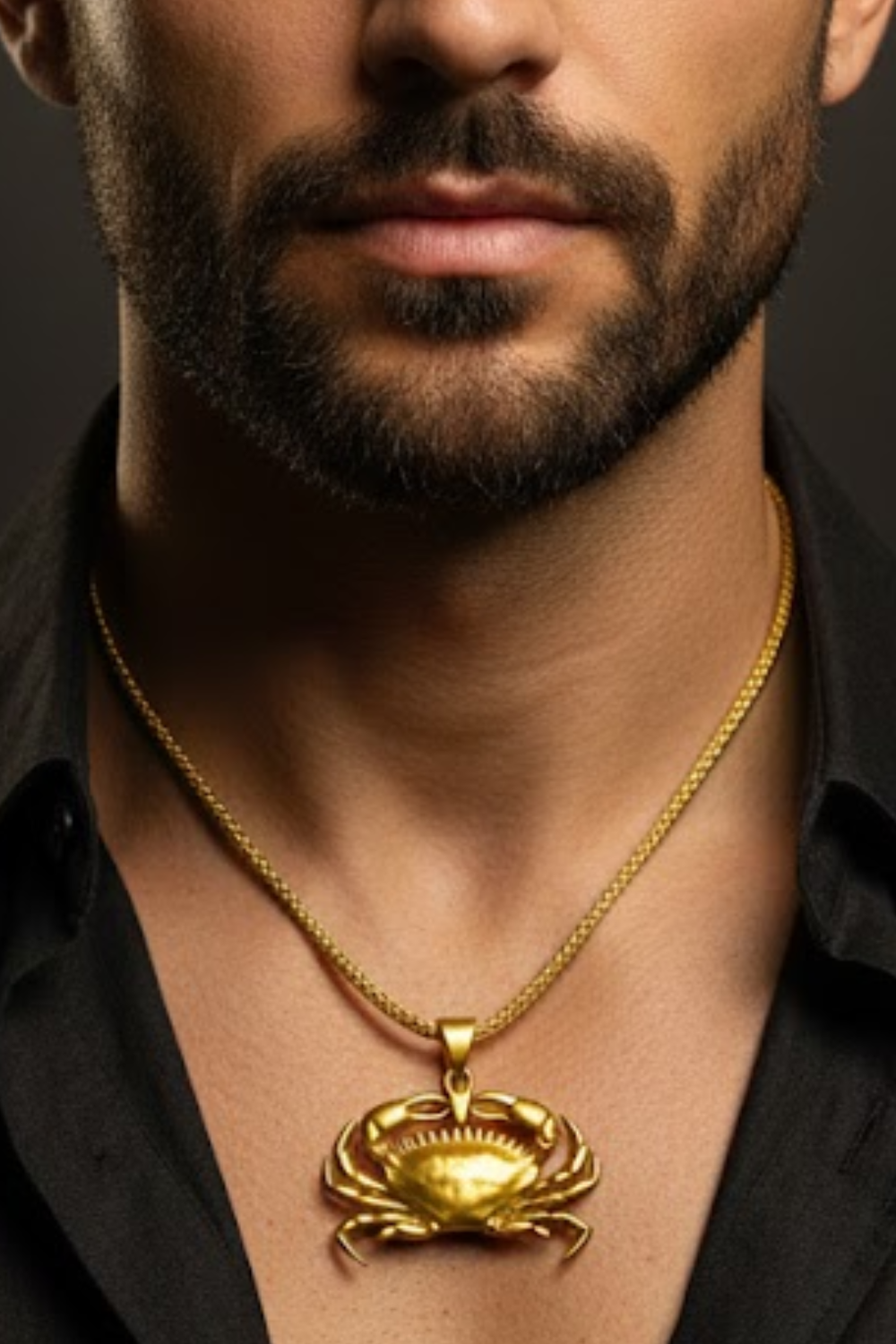 A close-up of a man's neck and chest area, with a gold-colored pendant featuring a crab design hanging from a chain around his neck.