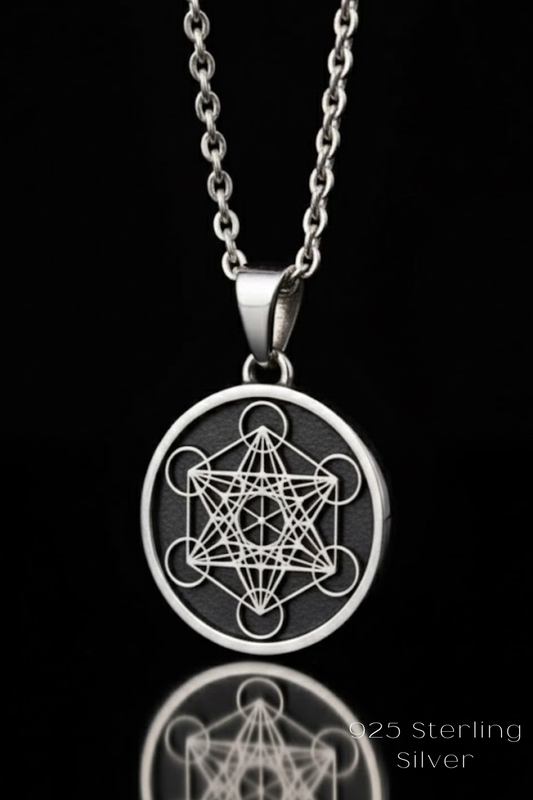 A silver necklace pendant with a circular design featuring a geometric pattern.