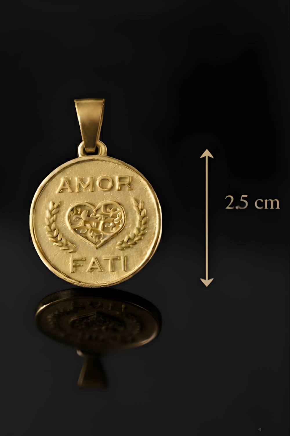 A gold-colored pendant with the words "Amor Fati" engraved on it, which means "love is a feast" in Italian. The pendant is approximately 2.5 cm in diameter.